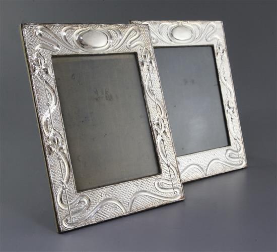 A pair of Edwardian Art Nouveau rectangular silver mounted photograph frames by Joseph & Richard Griffin, 30.3cm.